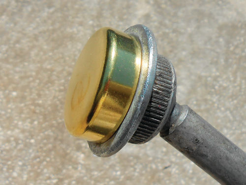 The plug sits over a boss on the end of the casting plug tool, and is driven in by its perimeter edge.