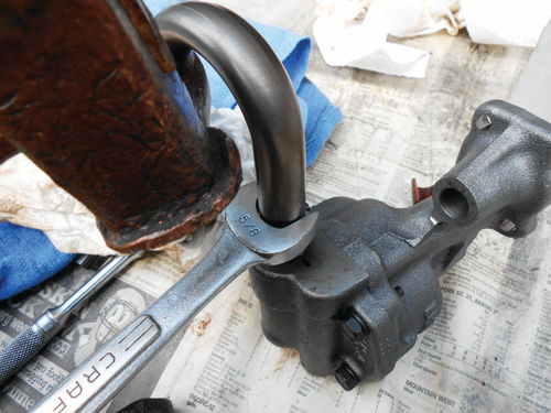 An open end wrench and hammer are used to install the pickup screen.