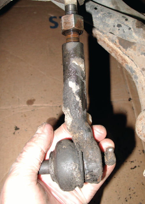 With the lock nut free, the tie-rod end (in my hand) simply spins off the tie rod.