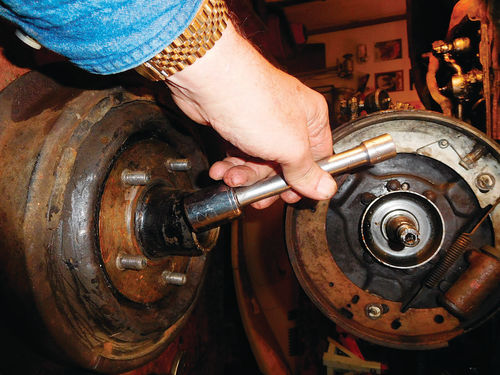 Since our bearing driver kit didn’t have a proper-sized disc, we had to use a socket of the right size and an extension bar to drive the larger inner wheel bearing and seal out of the inner side of the brake drum.