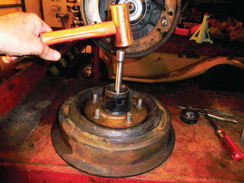 The inner wheel bearing and seal are sitting at the inner end of the brake drum opening and a few hammer blows will knock them out for cleaning.