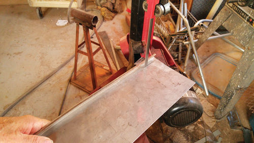 Cutting the cover piece with a band saw.