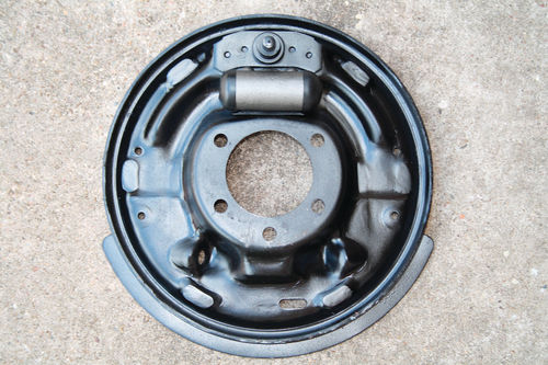 A restored backing plate with a new wheel cylinder attached is shown.