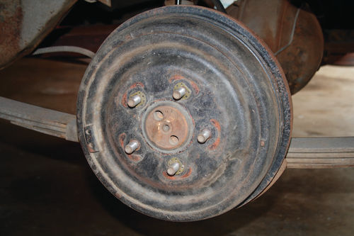 This view of an exposed brake drum reveals something about how original this car really is—note those three drum retainers on the wheel studs.