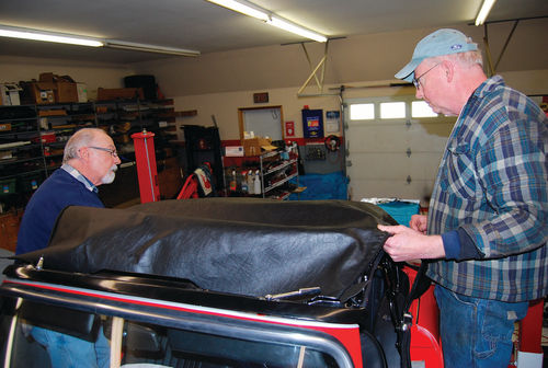 Ken and Bob worked together to pull, stretch and test fit the convertible top before placing it in its final position with fasteners and glue.