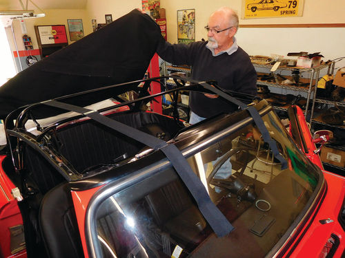 Ken Nimmocks slowly and carefully installed the convertible top on the restored top frame. Note the webbing’s attachment to the top of the windshield.