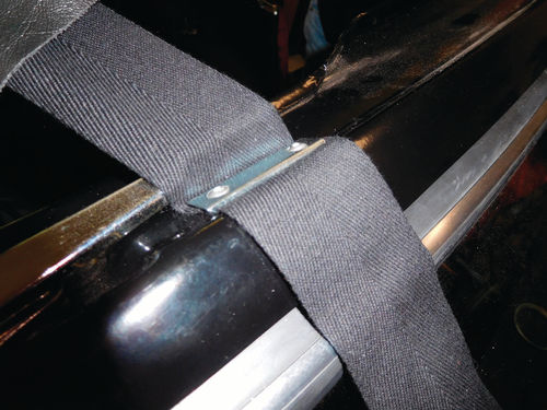 Different carmakers use different methods of attaching support webbing to the windshield frame. Triumph uses plates screwed in on top of the webbing.
