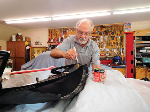 Ken applies the DAP Weldwood contact cement that he prefers for convertible top installations.