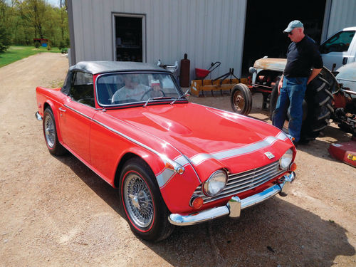 Bob Hansen watches the delivery of the Triumph to its owner after an 18-month restoration.