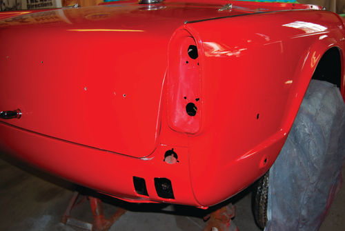 The car had been bumped once below the right taillight and this section had to be completely refinished after the first application of paint at another shop.