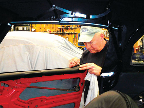 The black vinyl trim pieces that also serve as grips for closing the doors had to be glued to the top of each door before installing the interior door panels.