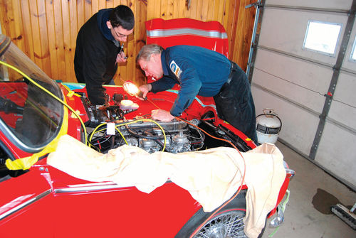 Dave Sarna (holding light) and Ian Diermeier got the TR250 engine started for the first time in 30 years.