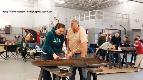 The author oversees some high-speed metal cutoff work perfomed by one of the students.