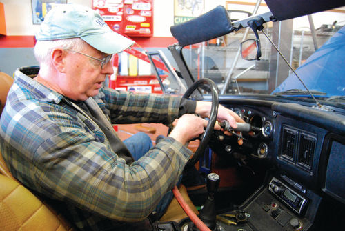 “Patient Bob” Hansen uses a Dremel tool to enlarge the dashboard opening. Working on, under and behind an MGB dashboard is no picnic.