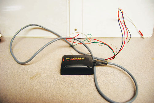 Plug the wiring harness into the slot on the side of the Sky Drive sending unit. The harness is designed with extra-long wires so that the Sky Drive unit can be moved around to test for its best location.