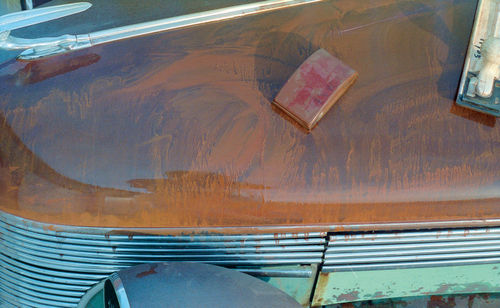 I used a rubber sanding block (center) and Hutchins Speed File (far right) to cut through the surface rust on the hood.