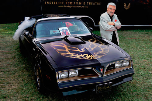 Burt Reynolds with a 1977 Pontiac Trans Am.