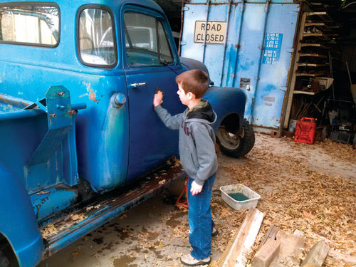 Nathaniel preps the door for the logo stencil.