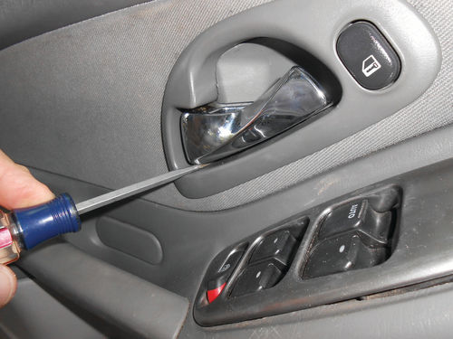 5. When starting work on the 2006 Malibu, lifting up on the screwdriver handle applies the needed downward pressure to release the trim catch.