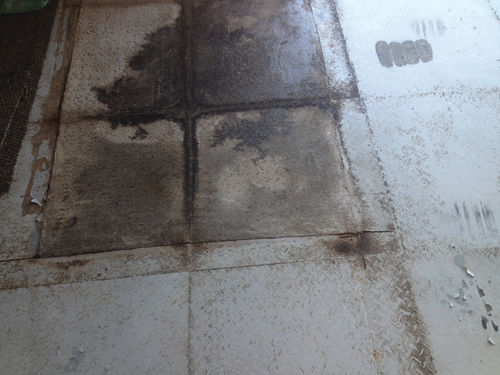 Once the floor tiles had been removed, the remaining automotive fluids residue was very apparent.