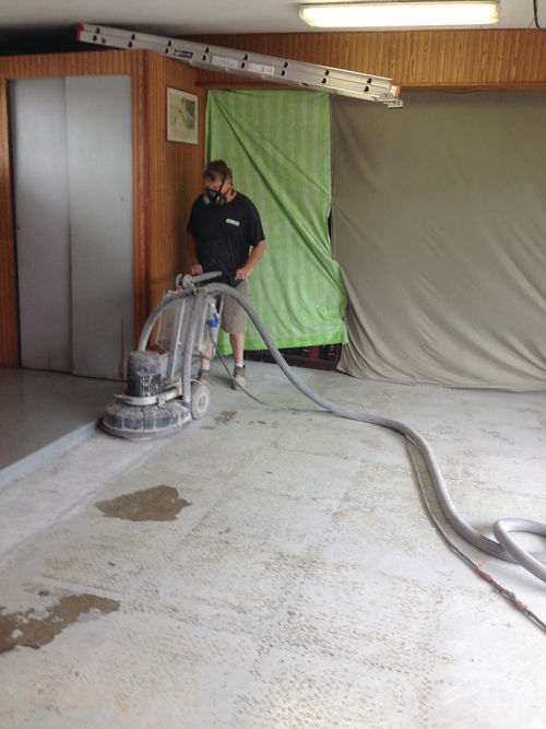 Applying the first two-part epoxy coating with a squeegee. That’s followed with a roller to level the coating. Note the spikes that allowed him to walk on the wet surface without disturbing it.