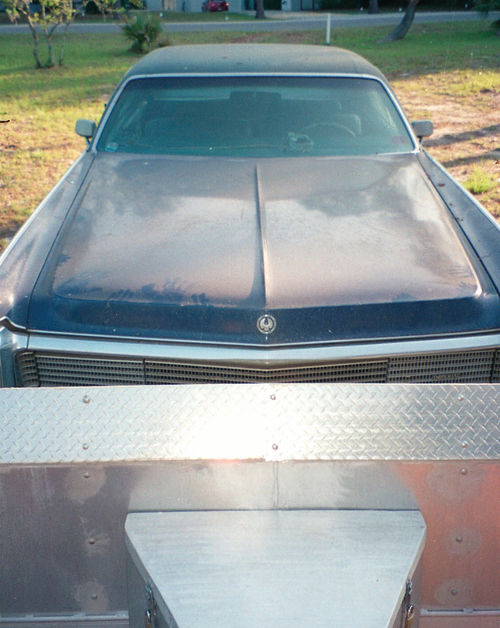 With a trunk deck nearly as long as its hood, the 1973 Imperial filled the trailer and hung over the back.