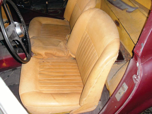 While tearing down the Jag for its restoration, the shop discovered a small sample of original ochre tan leather and used that as the basis for the new interior. At some point the car also had received a coat of burgundy paint.