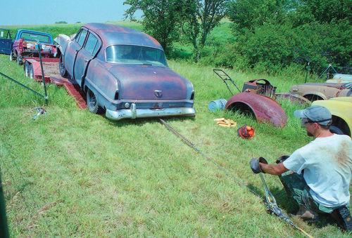 With four frozen brake drums, the Plymouth didn’t want to budge when I got it home. By wetting down the trailer with water and dishwashing soap, however, I used a deadman stake and come-along to winch it off the trailer.