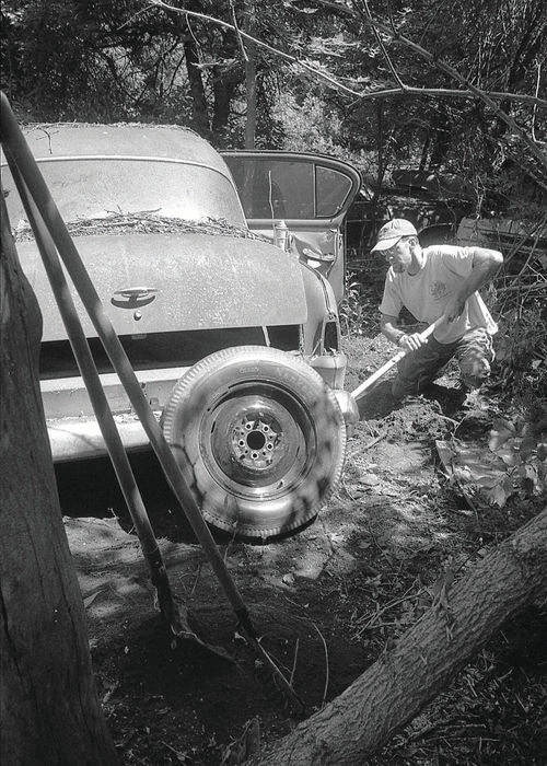 With my shovel and floor jack, I dig out and raise the car so I can slip a wheel on its right rear hub.