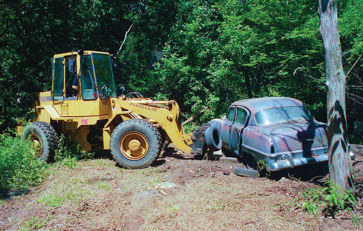 Mark begins the lift… and ultimately hoists the car skyward (pictured left) to clear other cars along the lane.