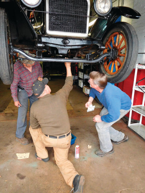 Teamwork was in order after a small hole was discovered in the oil pan. Gasket material, a screw and some 5-minute epoxy stopped the oil leak.