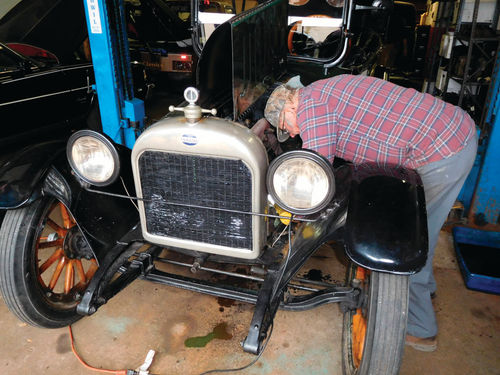 Bob Buchman does some tuning on the carburetor.