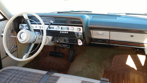 The parchment vinyl and cloth interior is original on this ’67 Country Squire.