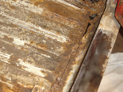 The rot extended to the inner rocker, formed where the floor pan curved up to the door sill.