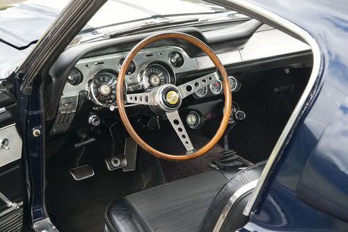 The dashboard, the gauges and the woodrimmed steering wheel add up to a 1960s interpretation of a GT car.