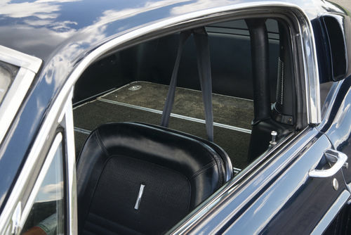 Behind the roll bar is the seat that folds down to provide the extra space a grand touring car really needs.