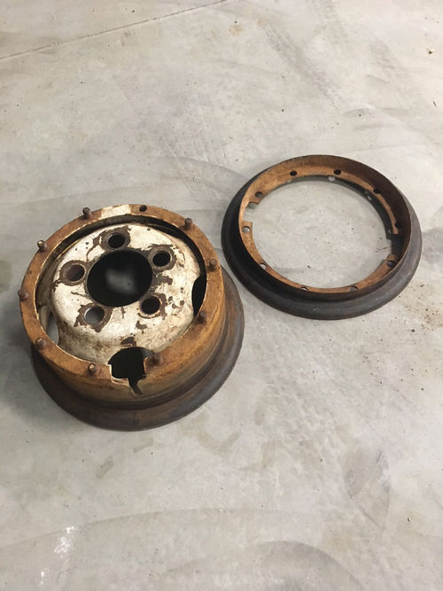 A two-piece wheel has been removed to be sand blasted and powder coated.