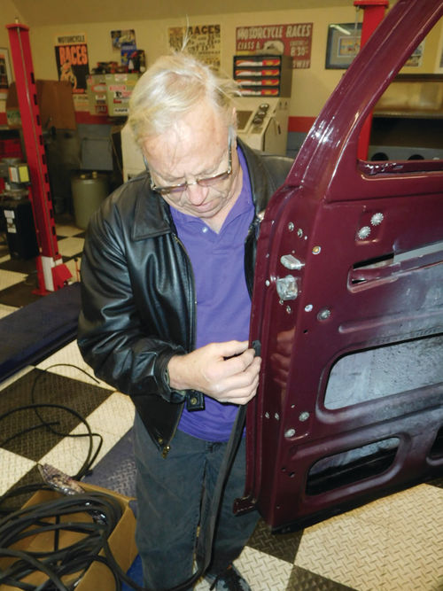 Joe Gilles of Fix-It Rubber, LLC, demonstrates how to fit a rubber door seal tight into the “corner” of the door. A specific side of the seal has to be glued against the metal.