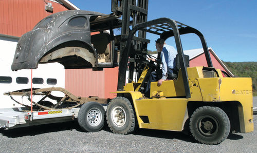 11. Using a Caterpillar forklift and great care, Art loaded the DeSoto body onto my trailer.