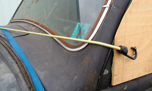 A long bungee cord saved the day when the left front window cover began flapping in the wind.