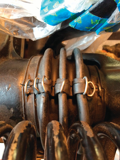 Not a pretty sight—the axle boot has to be held together with hog ring clamps.