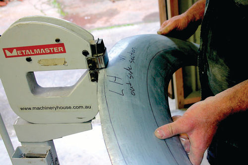 An English wheel and shrinking tools are used to shape the panel.