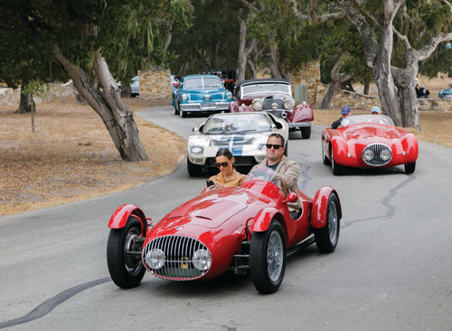 A 1949 Italian-built OSCA MT4 Siluro Spider leads a vintage parade near the concours grounds.