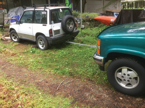 Using a tow chain, the Tracker was towed backward out of the yard and onto firm ground.