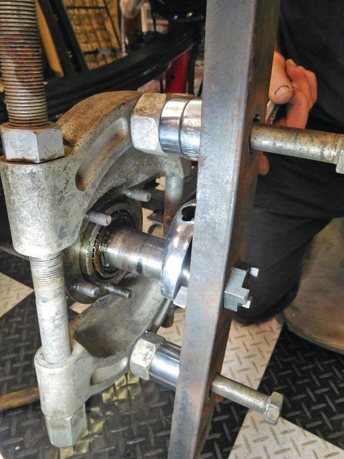 Large washers and nuts were used as spaces to create the pulling pressure needed to ease the bearing and race out of the axle.