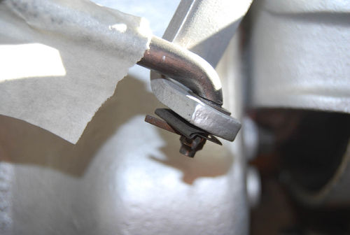 Here’s another linkage connection where a “tin nut” is used instead of a washer to hold the rod in place. No clevis pin is used in this type of connection.