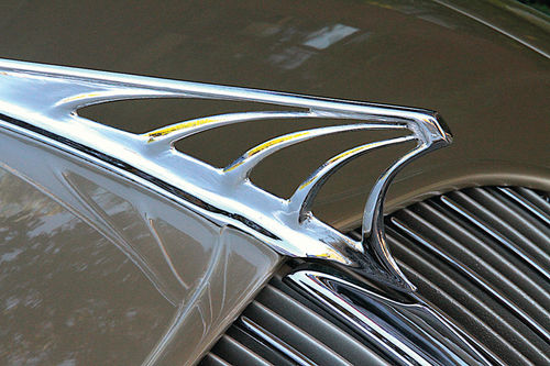 The hood ornament is an almost unrecognizably stylized eagle that looks more like a spider web.