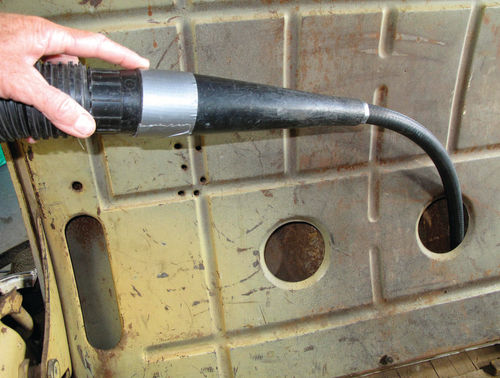 A heater hose created a vacuum attachment flexible enough to reach inside the rumble-seat lid.