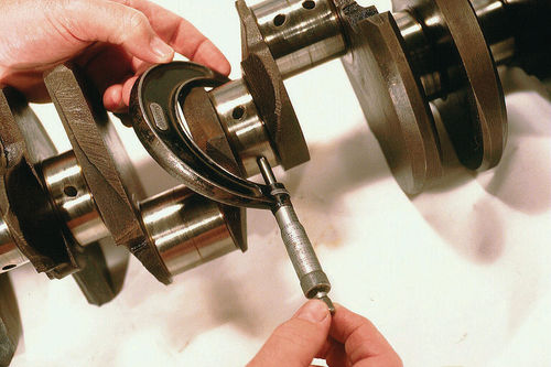 Vernier calipers are the standard at machine shops, but a dial caliper like this one is easier to read.
