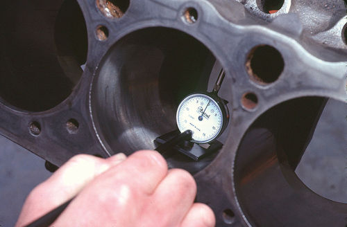 A dial gauge mounted in a special jig is the most reliable way to measure for taper and out-of-roundness in cylinder bores.